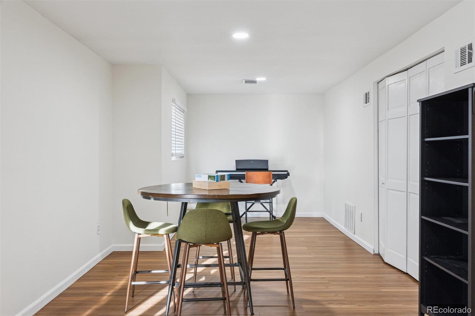 9471 Burlington Lane Highlands Ranch, CO 80130 - Photo 31 of 50 a view of a dining room with furniture and wooden floor
