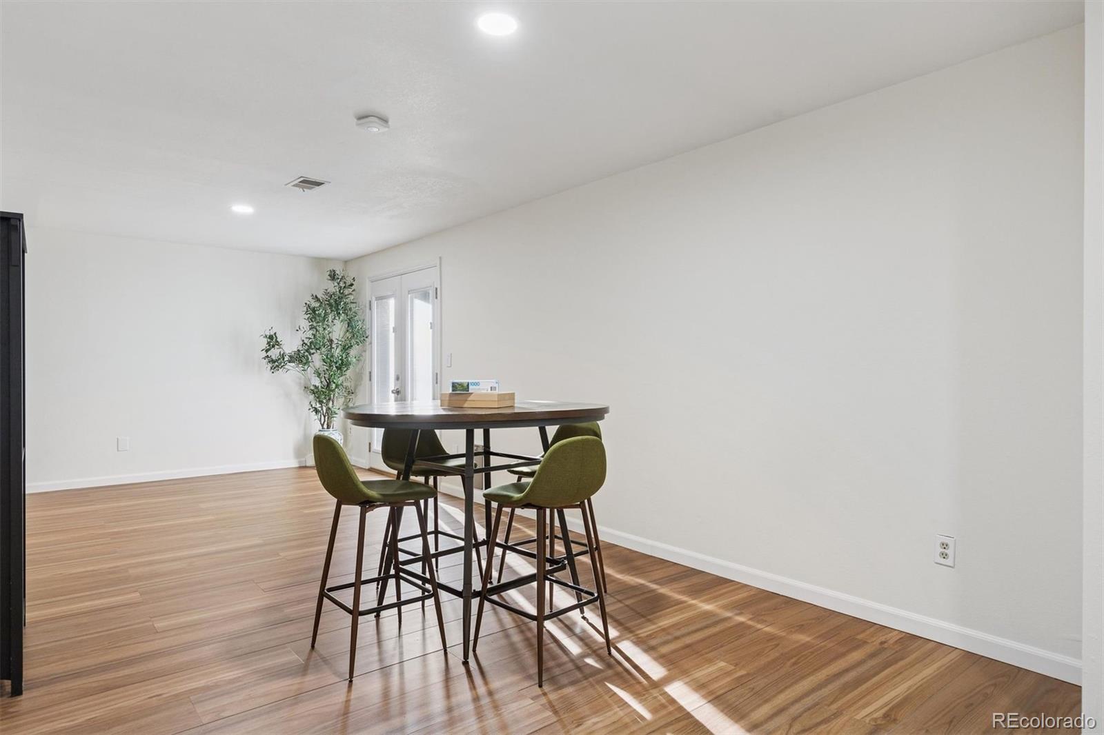 9471 Burlington Lane Highlands Ranch, CO 80130 - Photo 33 of 50 a view of a dining room with furniture and wooden floor