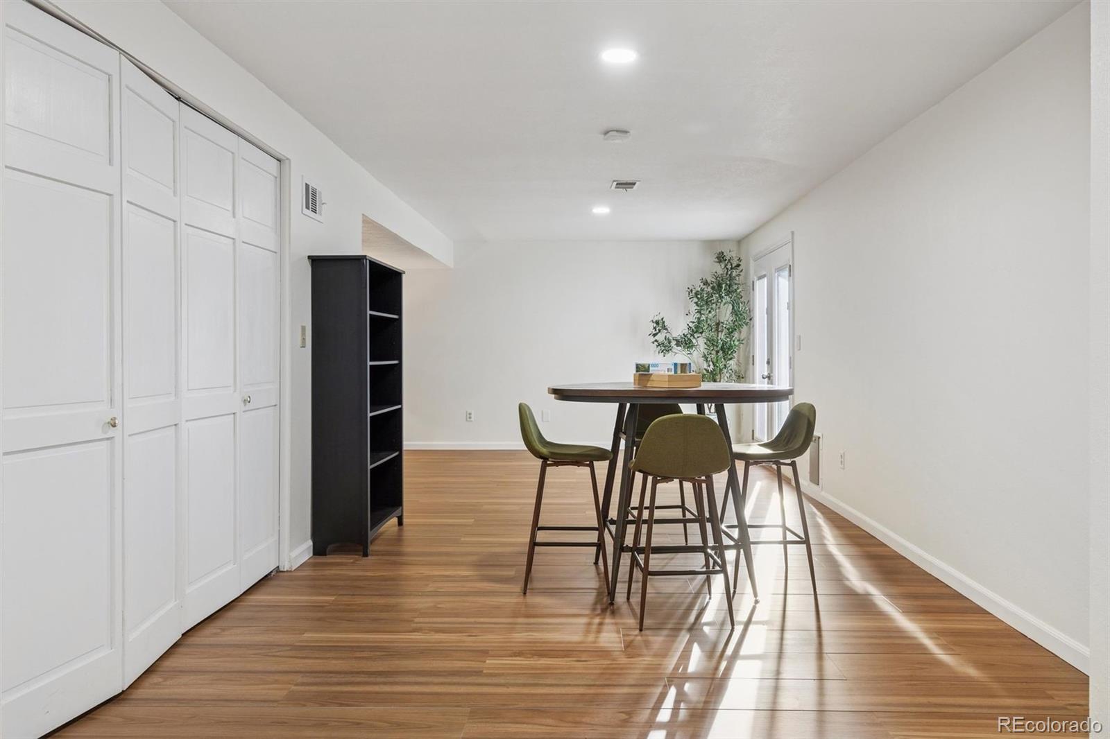 9471 Burlington Lane Highlands Ranch, CO 80130 - Photo 34 of 50 a view of a dining room with furniture and wooden floor