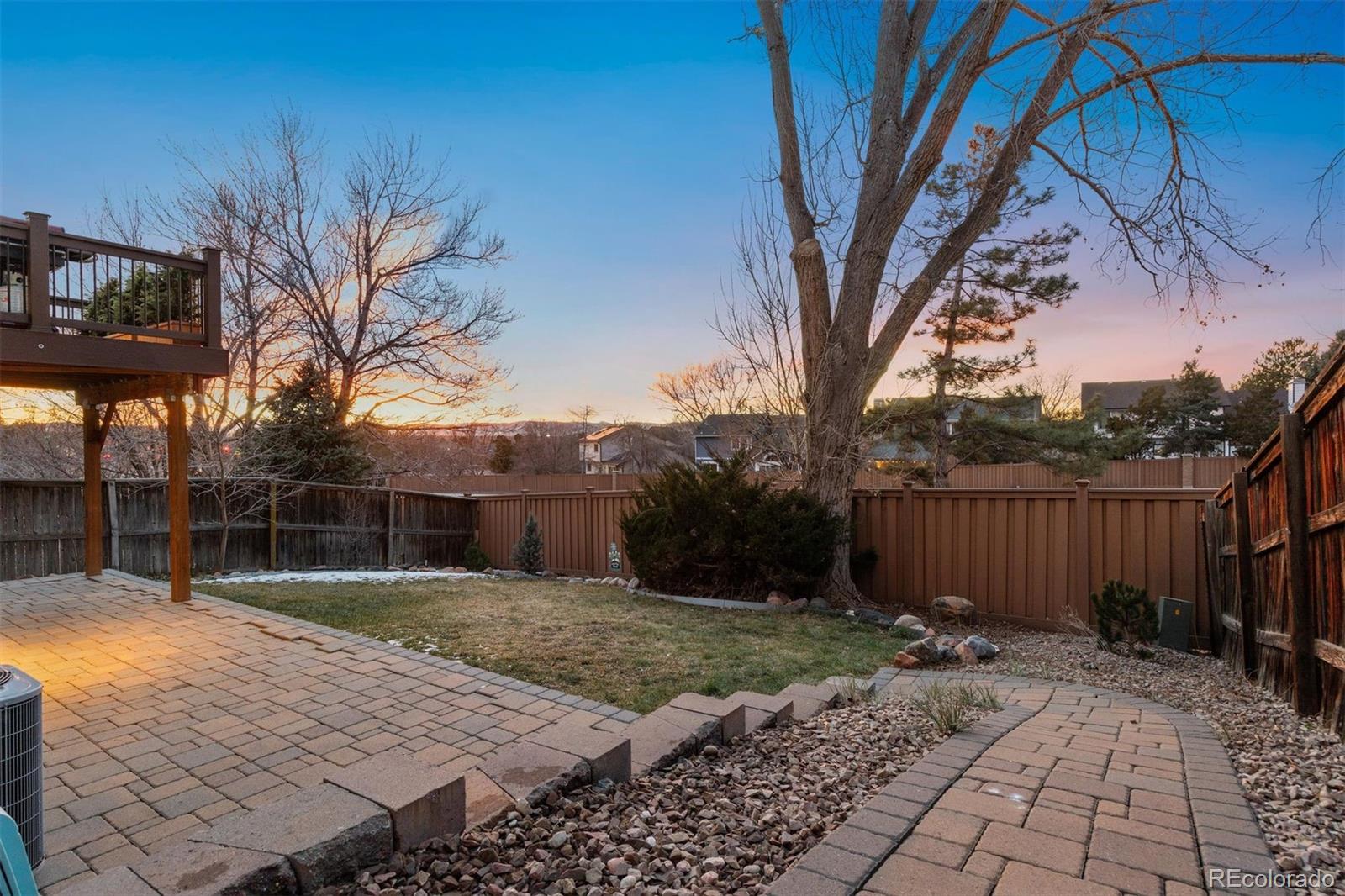 9471 Burlington Lane Highlands Ranch, CO 80130 - Photo 44 of 50 a view of backyard with potted plants and large tree
