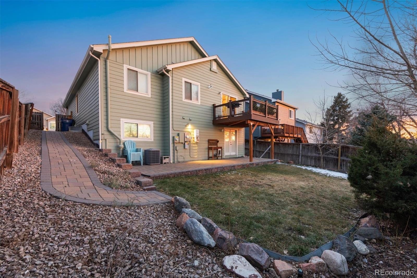 9471 Burlington Lane Highlands Ranch, CO 80130 - Photo 47 of 50 a front view of a house with a yard