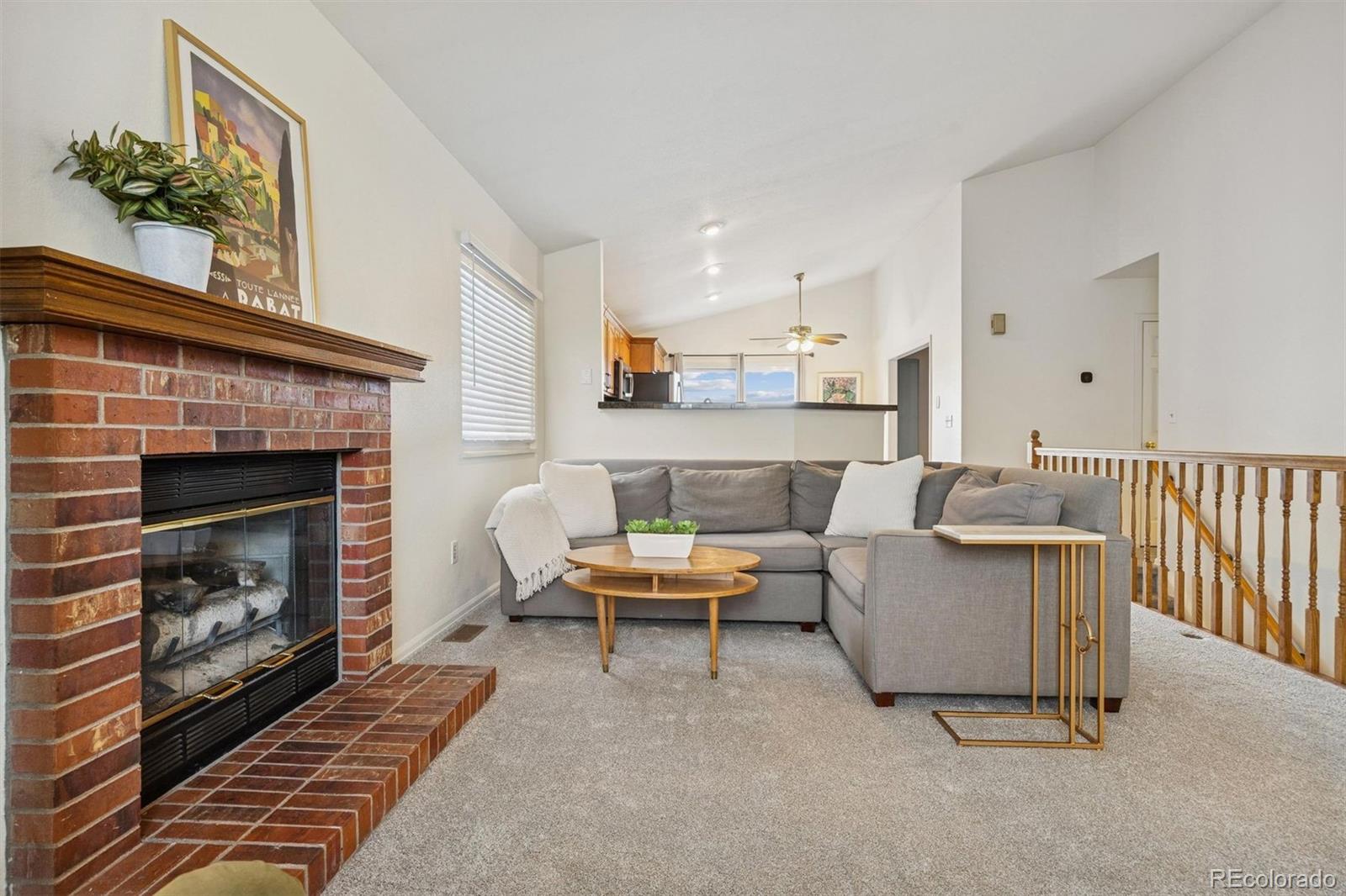 9471 Burlington Lane Highlands Ranch, CO 80130 - Photo 6 of 50 a living room with furniture a fireplace and a fireplace