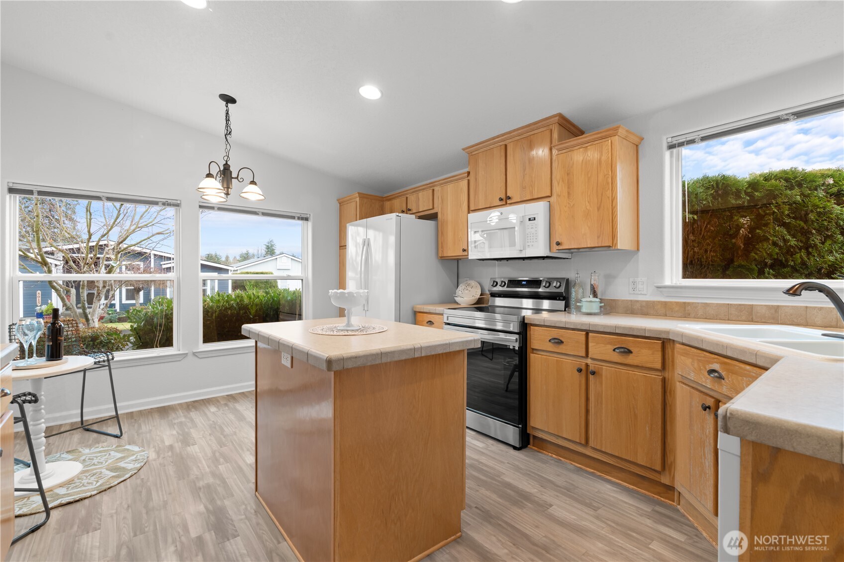 8014 18th Lane Southeast Lacey, WA 98503 - Photo 12 of 32 a kitchen with stainless steel appliances granite countertop a stove a sink dishwasher and a refrigerator with wooden floor