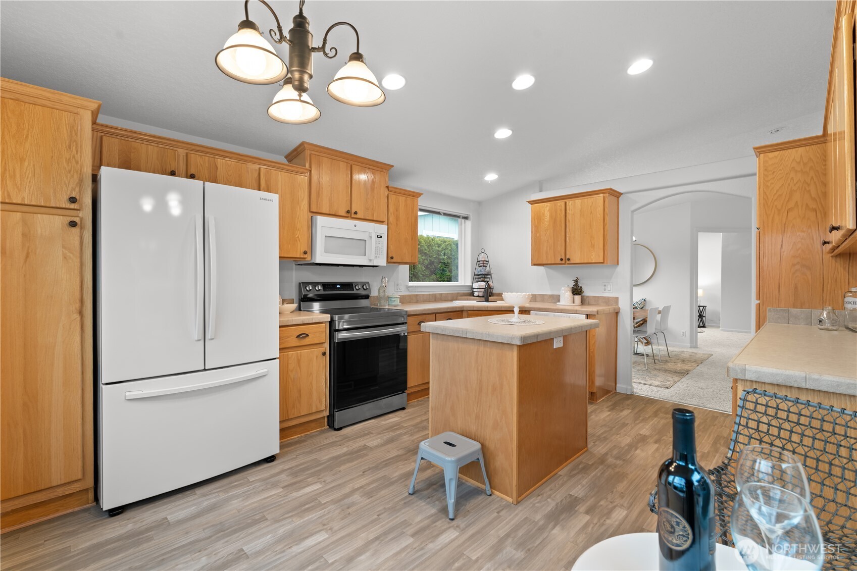 8014 18th Lane Southeast Lacey, WA 98503 - Photo 13 of 32 a kitchen with a refrigerator and a stove top oven