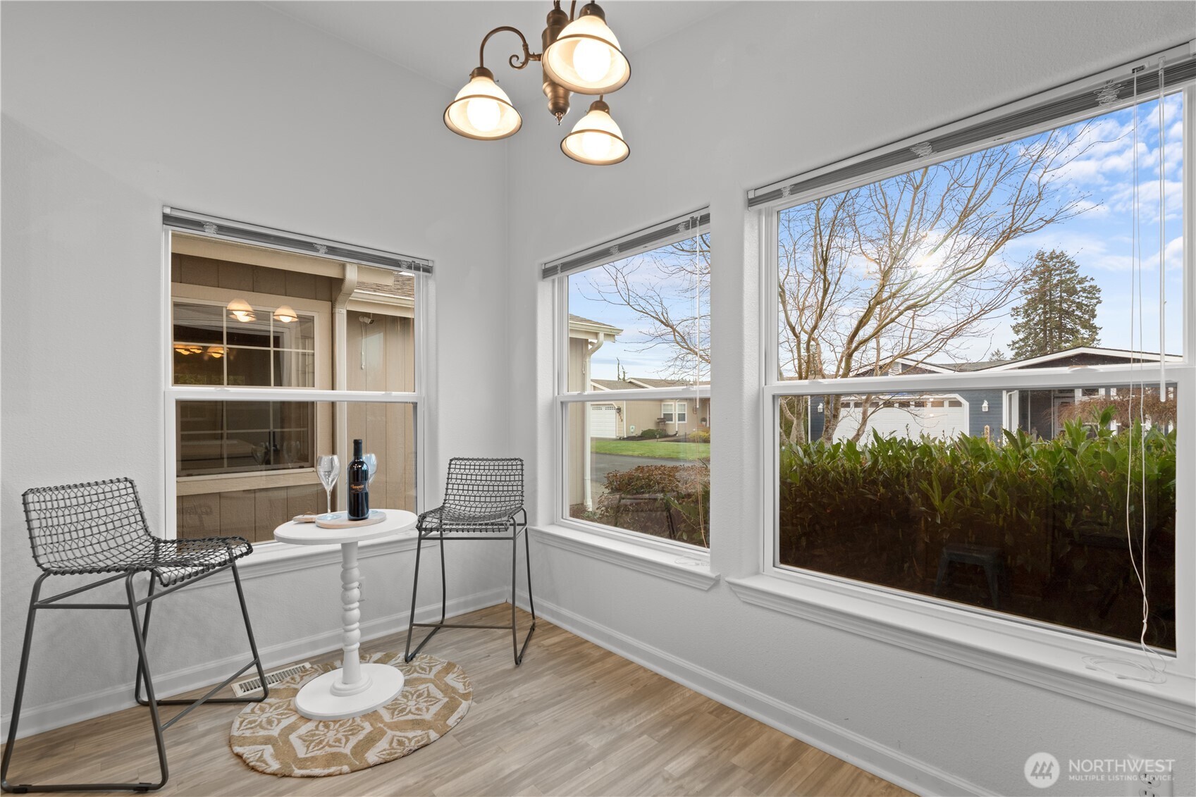 8014 18th Lane Southeast Lacey, WA 98503 - Photo 15 of 32 a dining room with wooden floor and a floor to ceiling window