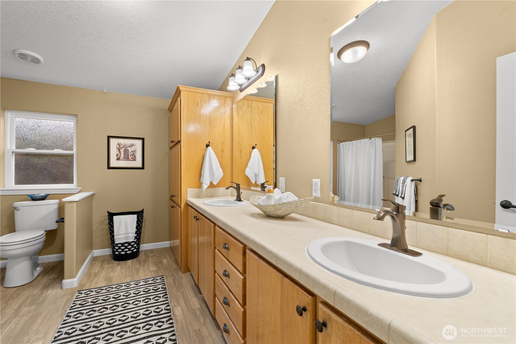8014 18th Lane Southeast Lacey, WA 98503 - Photo 21 of 32 a bathroom with a double vanity sink toilet and a mirror