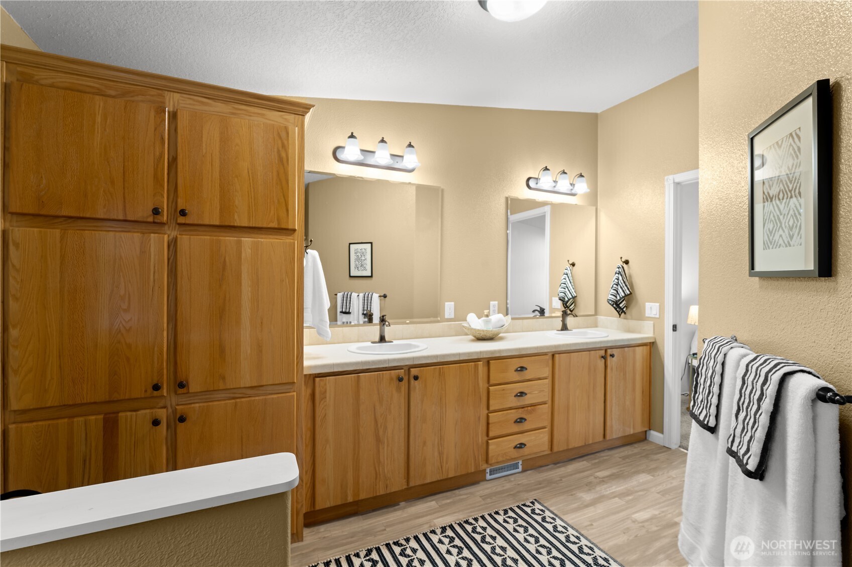 8014 18th Lane Southeast Lacey, WA 98503 - Photo 24 of 32 a bathroom with a double vanity sink a mirror and a bathtub