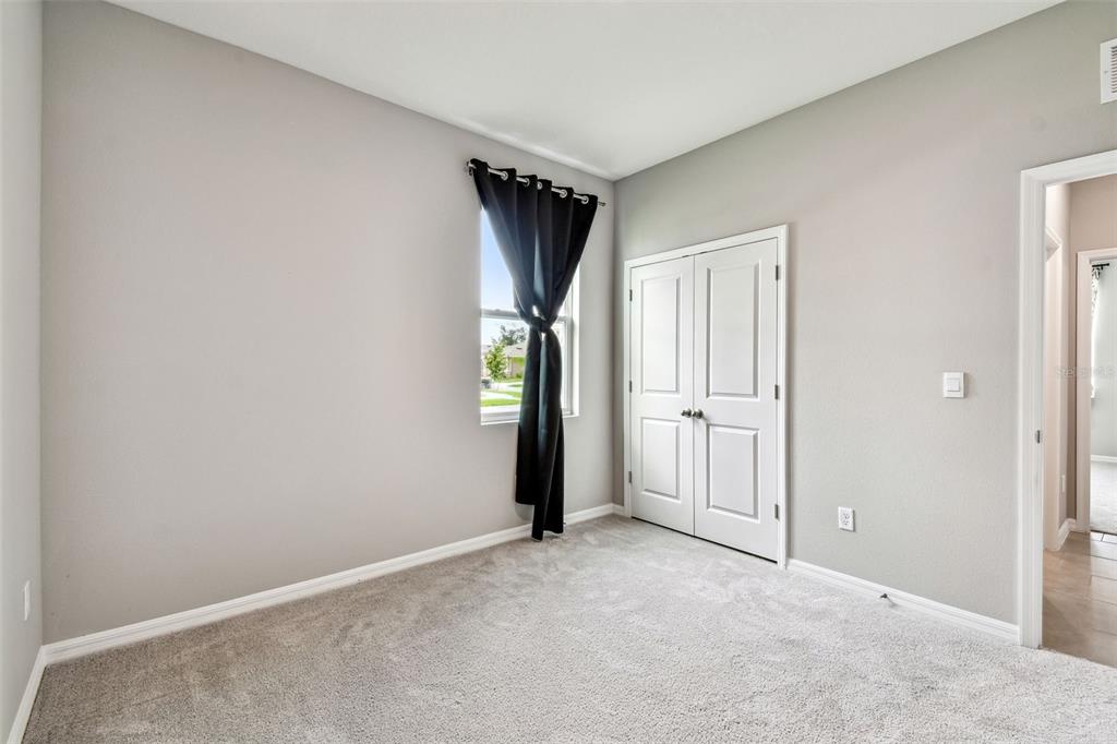 33870 Field Maple Loop Wesley Chapel, FL 33545 - Photo 14 of 38 an empty room with closet and a window