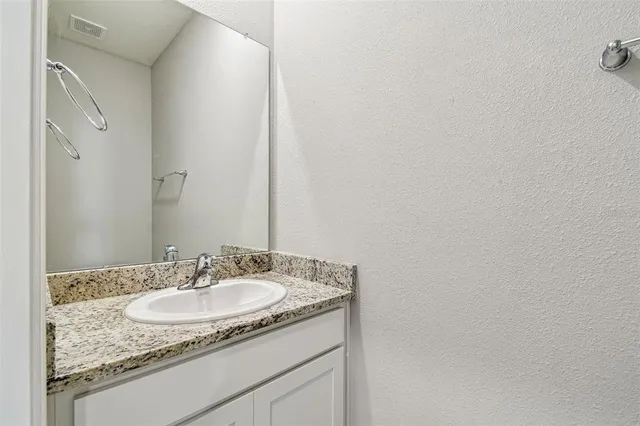 a view of kitchen with stainless steel appliances kitchen island granite countertop a refrigerator and a stove top oven