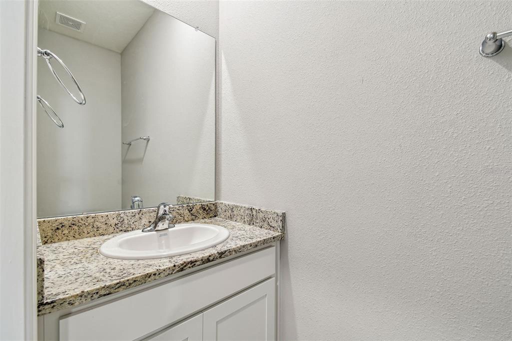 33870 Field Maple Loop Wesley Chapel, FL 33545 - Photo 16 of 38 a sink and mirror