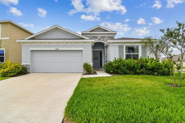 a front view of house with yard and green space