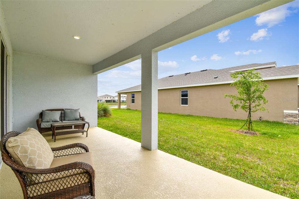33870 Field Maple Loop Wesley Chapel, FL 33545 - Photo 3 of 38 a front view of a house with garden