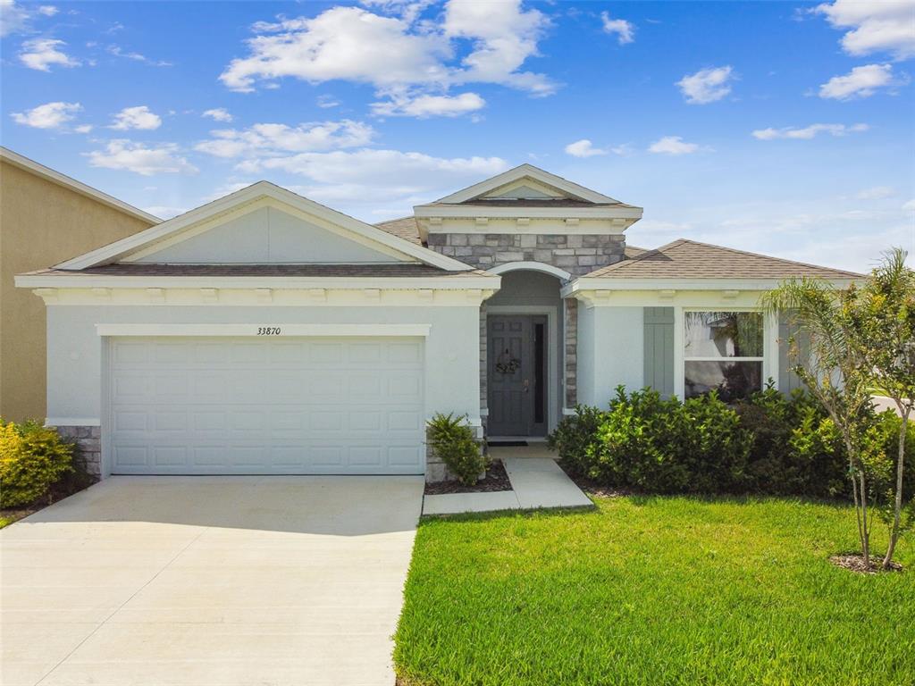 33870 Field Maple Loop Wesley Chapel, FL 33545 - Photo 32 of 38 a front view of a house with garden