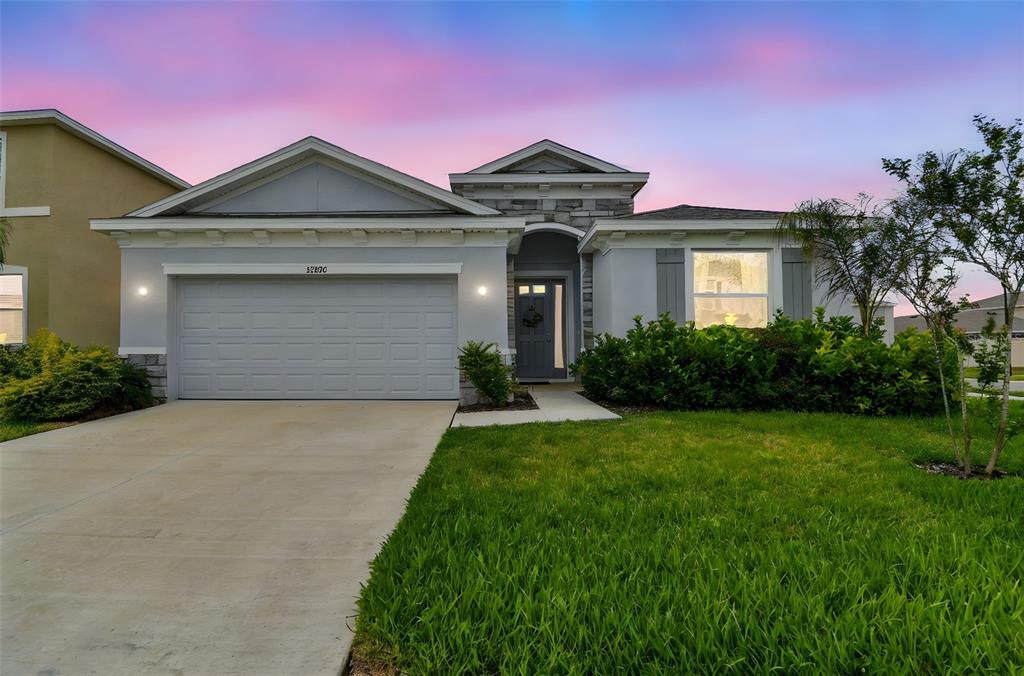 33870 Field Maple Loop Wesley Chapel, FL 33545 - Photo 34 of 38 a front view of a house with a yard and garage