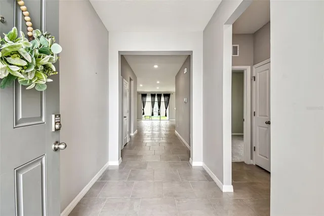 a view of hallway with livingroom and chandelier