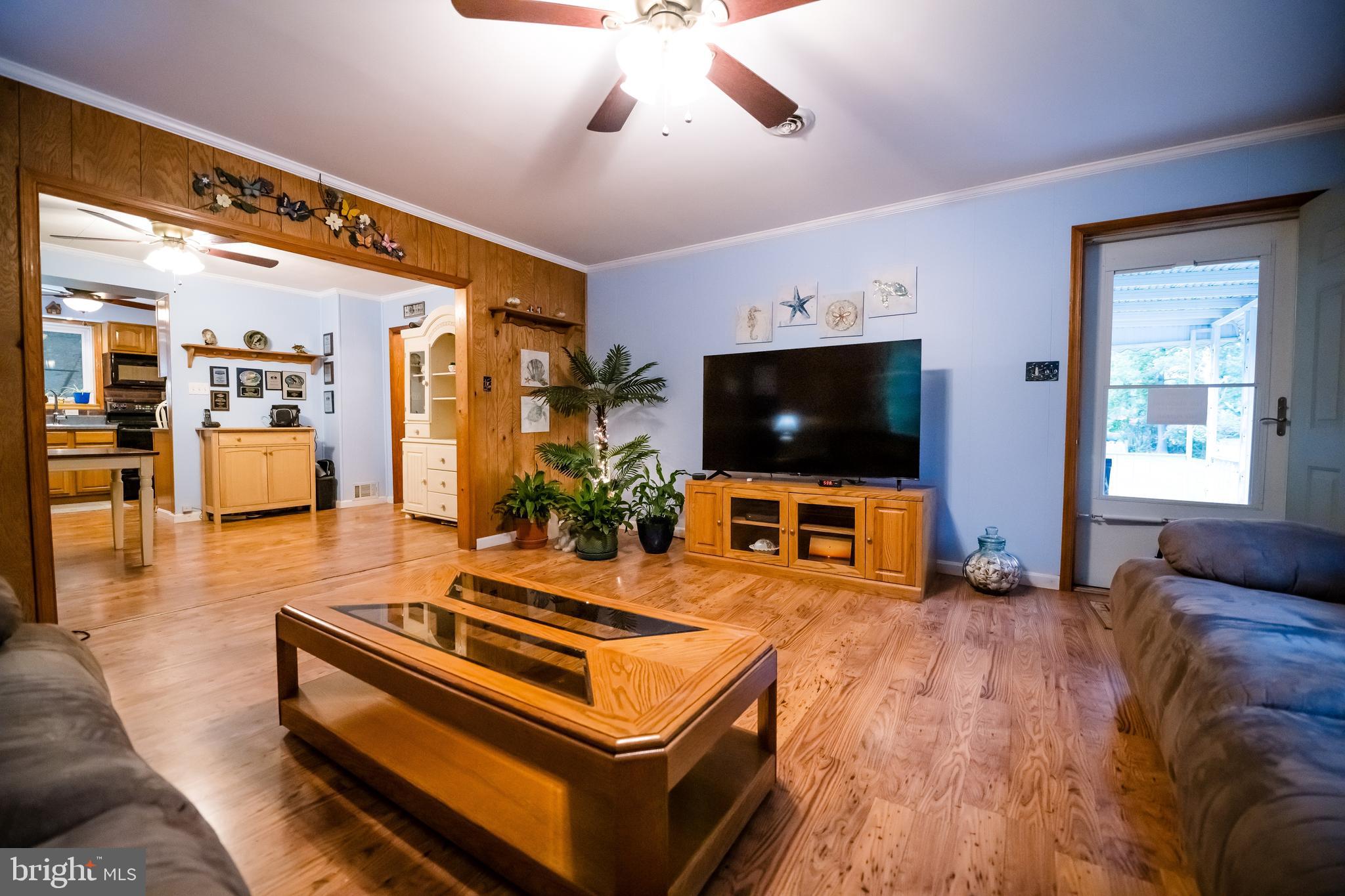 1107 Maple Road Essex, MD 21221 - Photo 21 of 42 a living room with furniture and a flat screen tv