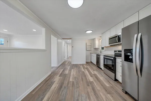 a kitchen with stainless steel appliances a refrigerator and a stove top oven