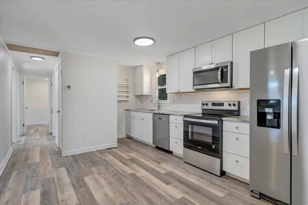 a kitchen with a sink stainless steel appliances and cabinets