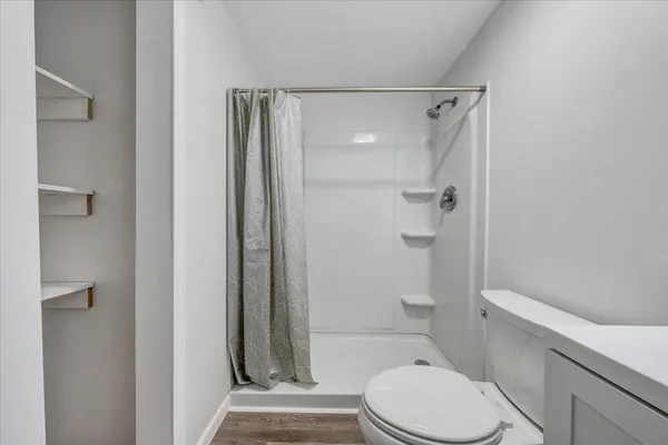 a white toilet sitting next to a bathroom