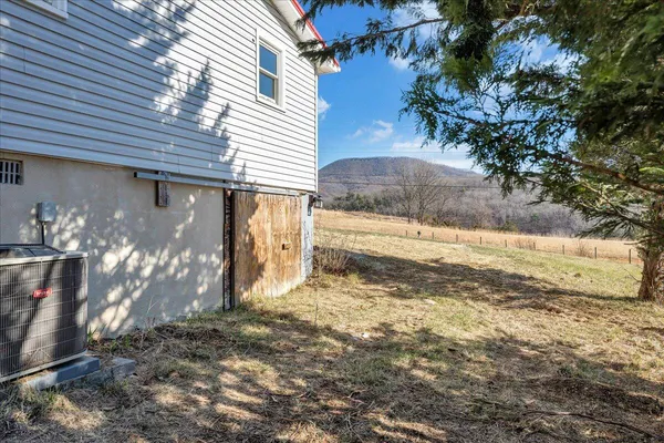 a view of a yard with wooden fence