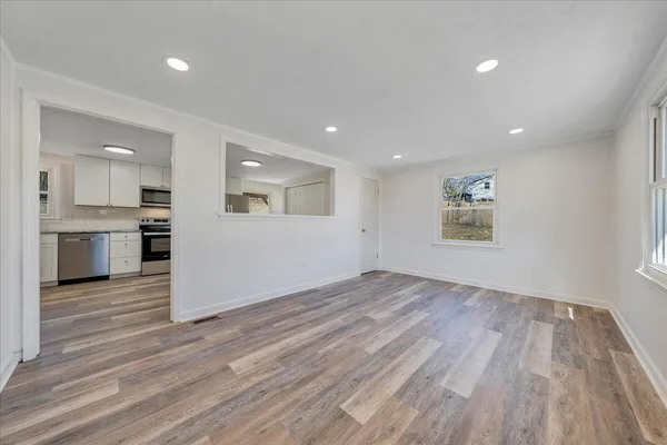 a view of a kitchen with wooden floor and a kitchen