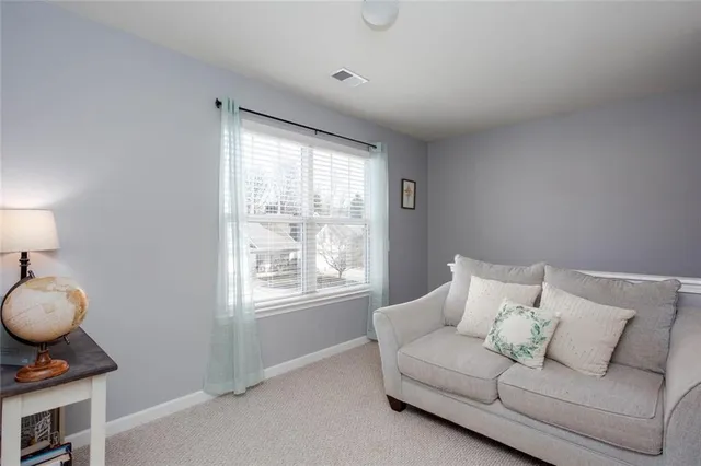 a living room with furniture and a walk in closet
