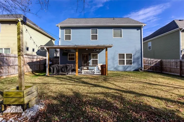an aerial view of a house with outdoor space and swimming pool