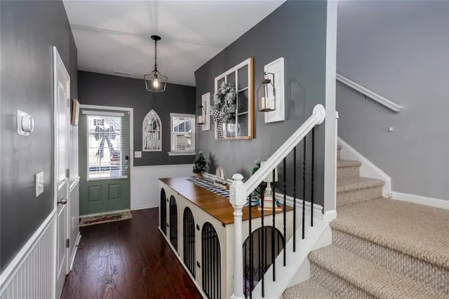 a view of entryway and hall with wooden floor