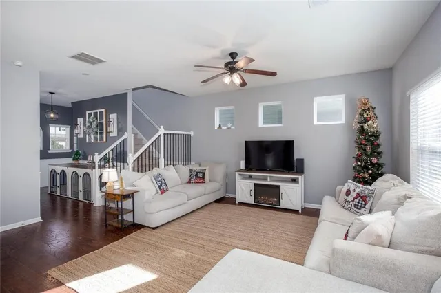 a living room with furniture and a flat screen tv