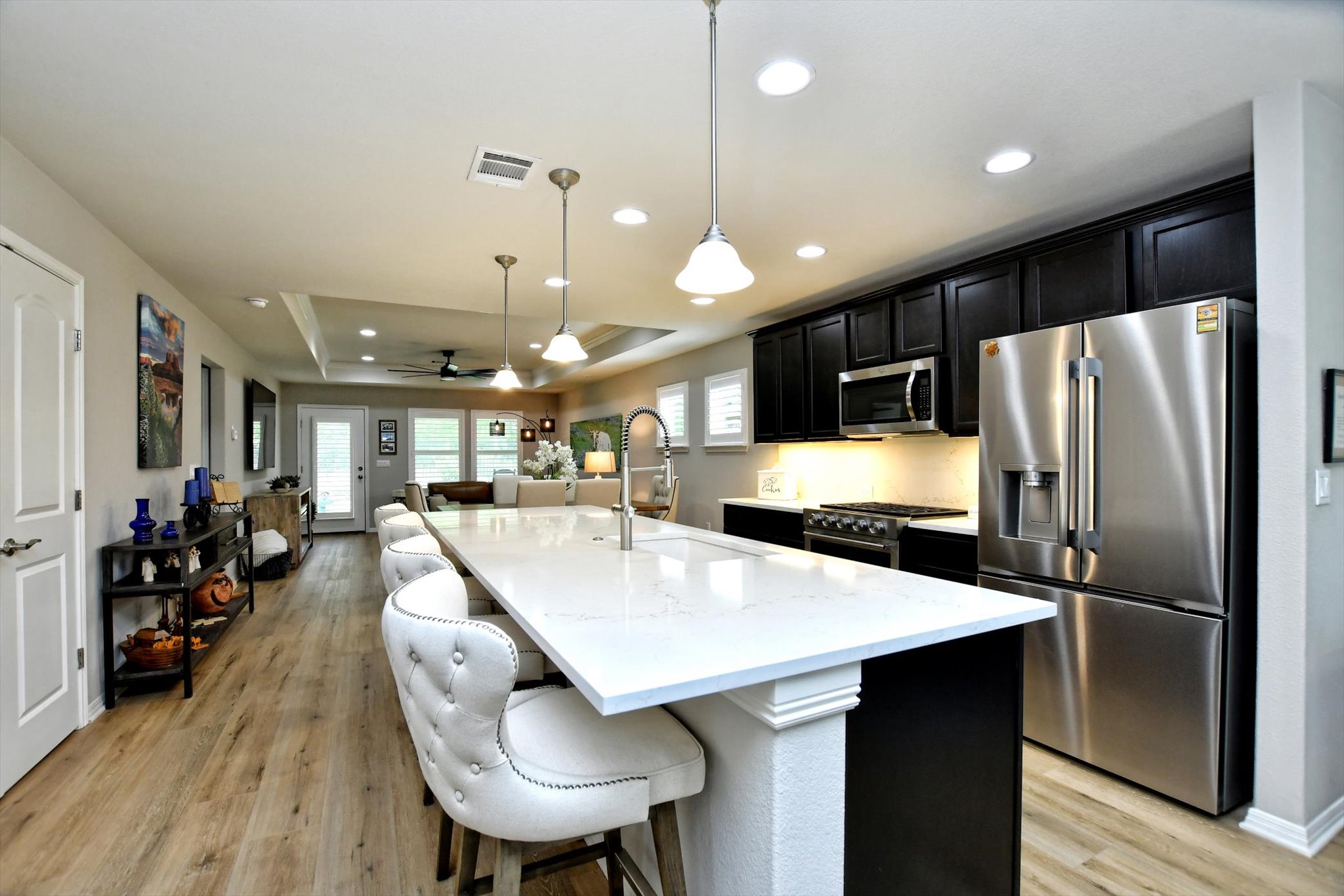 231 Hobby Street Georgetown, TX 78633 - Photo 9 of 29 An inviting open-concept kitchen features a spacious island and seamlessly connects to the living area.