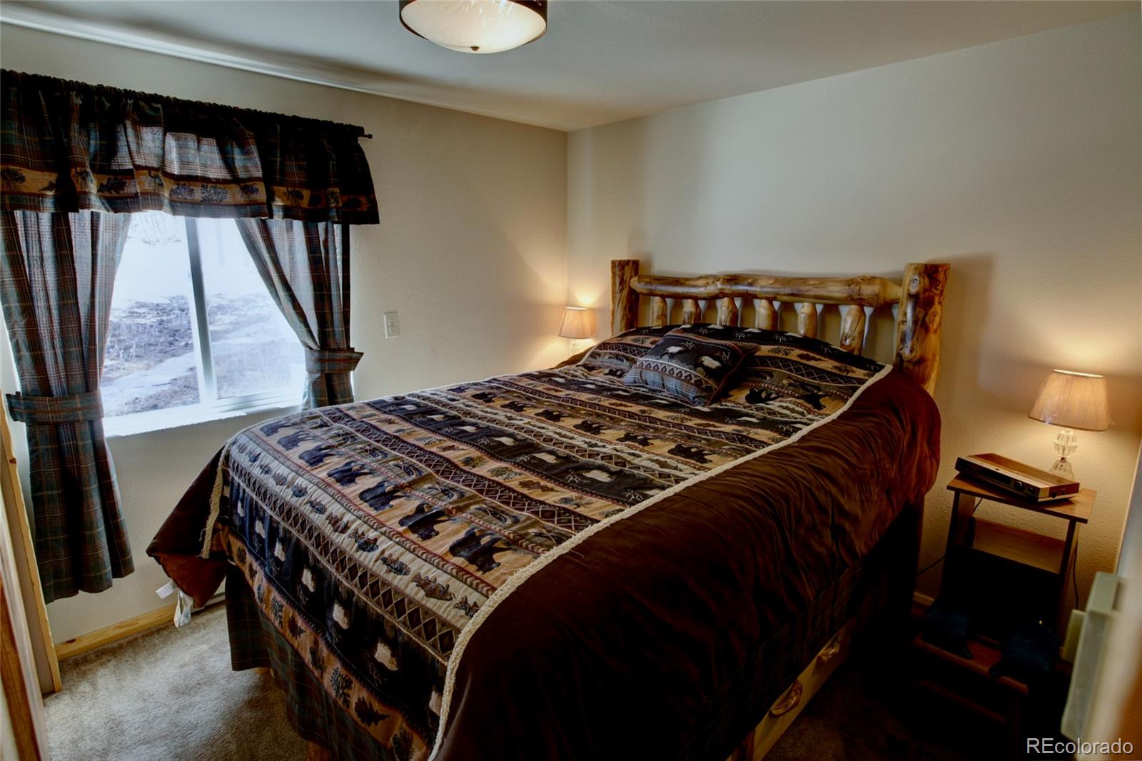 530 Red Feather Road Cotopaxi, CO 81223 - Photo 23 of 46 a bed sitting in a bedroom next to a window
