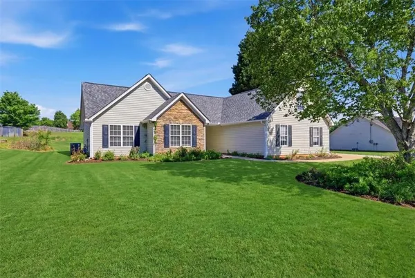 a front view of a house with a yard