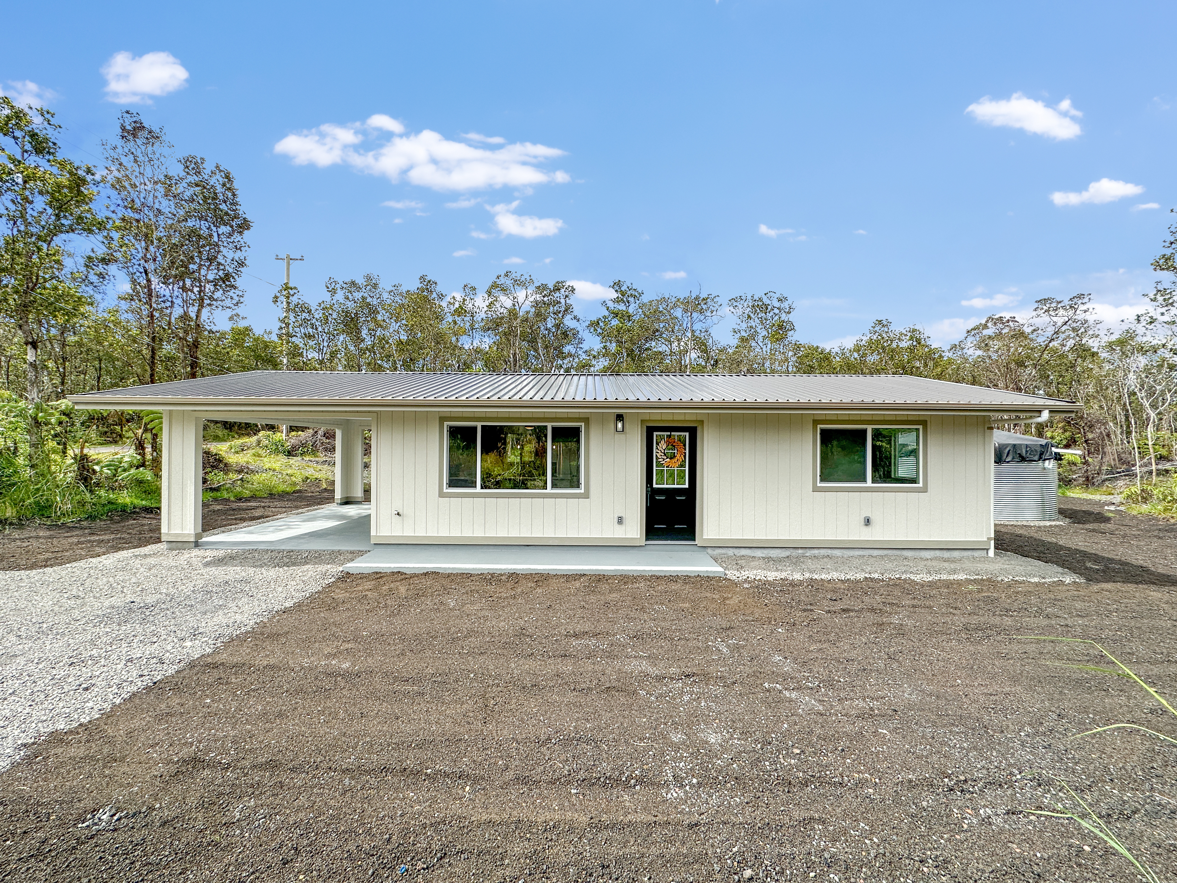 11-3116-a Mokuna Street Mountain View, HI 96771 - Photo 1 of 15 a front view of a house with a yard and potted plants