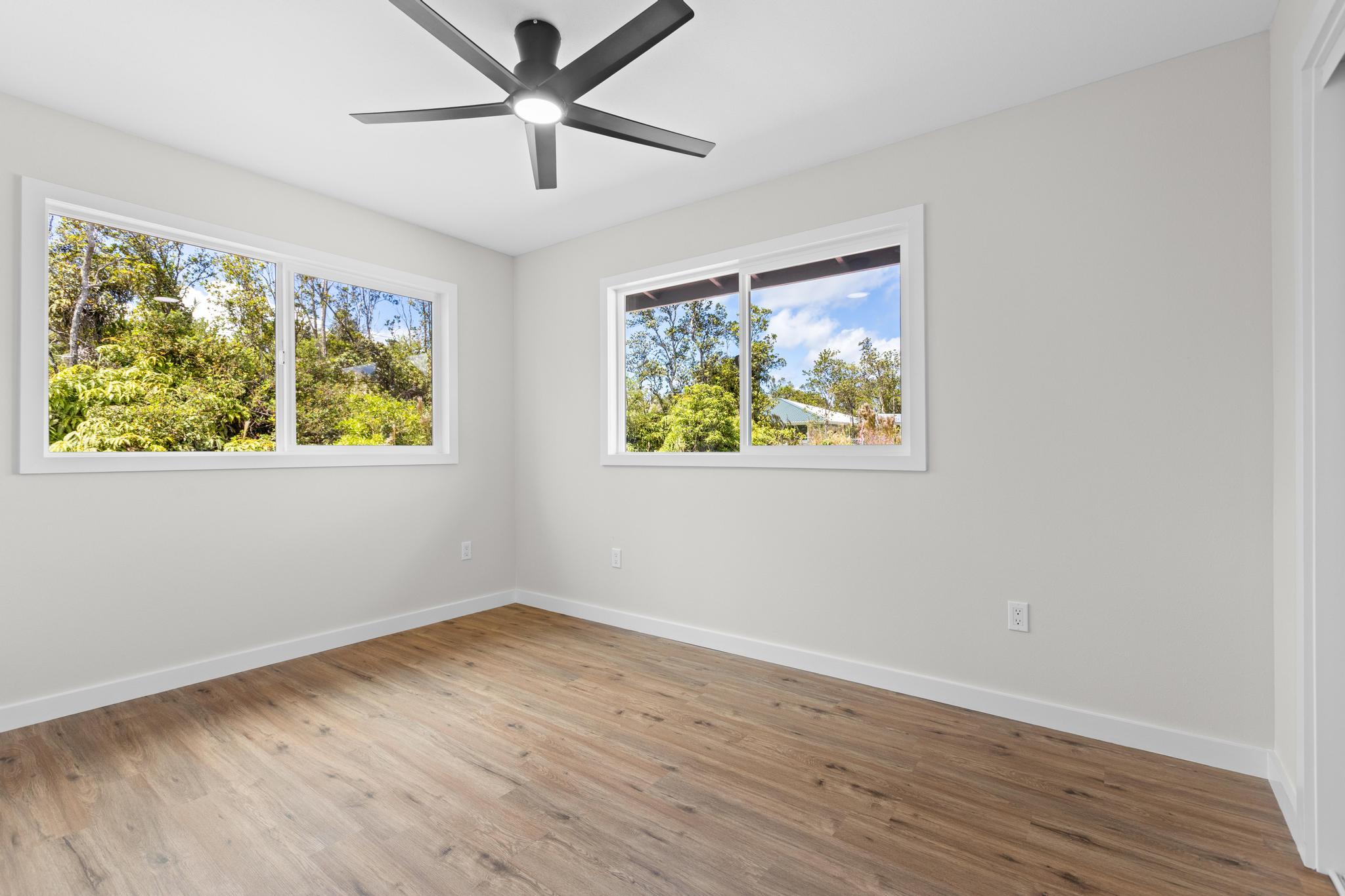 11-3116-a Mokuna Street Mountain View, HI 96771 - Photo 14 of 15 a view of room with window ceiling fan and wooden floor