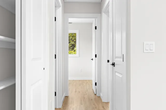 a view of a hallway with wooden floor