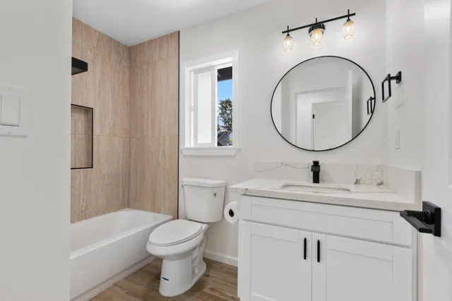 a bathroom with a sink toilet and a mirror