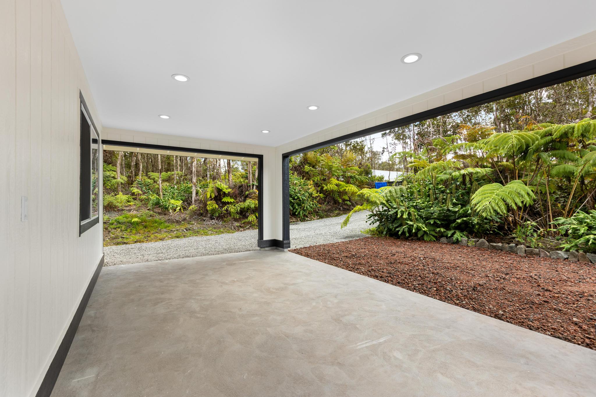 11-3116-a Mokuna Street Mountain View, HI 96771 - Photo 8 of 15 a view of a garden with plants and large windows