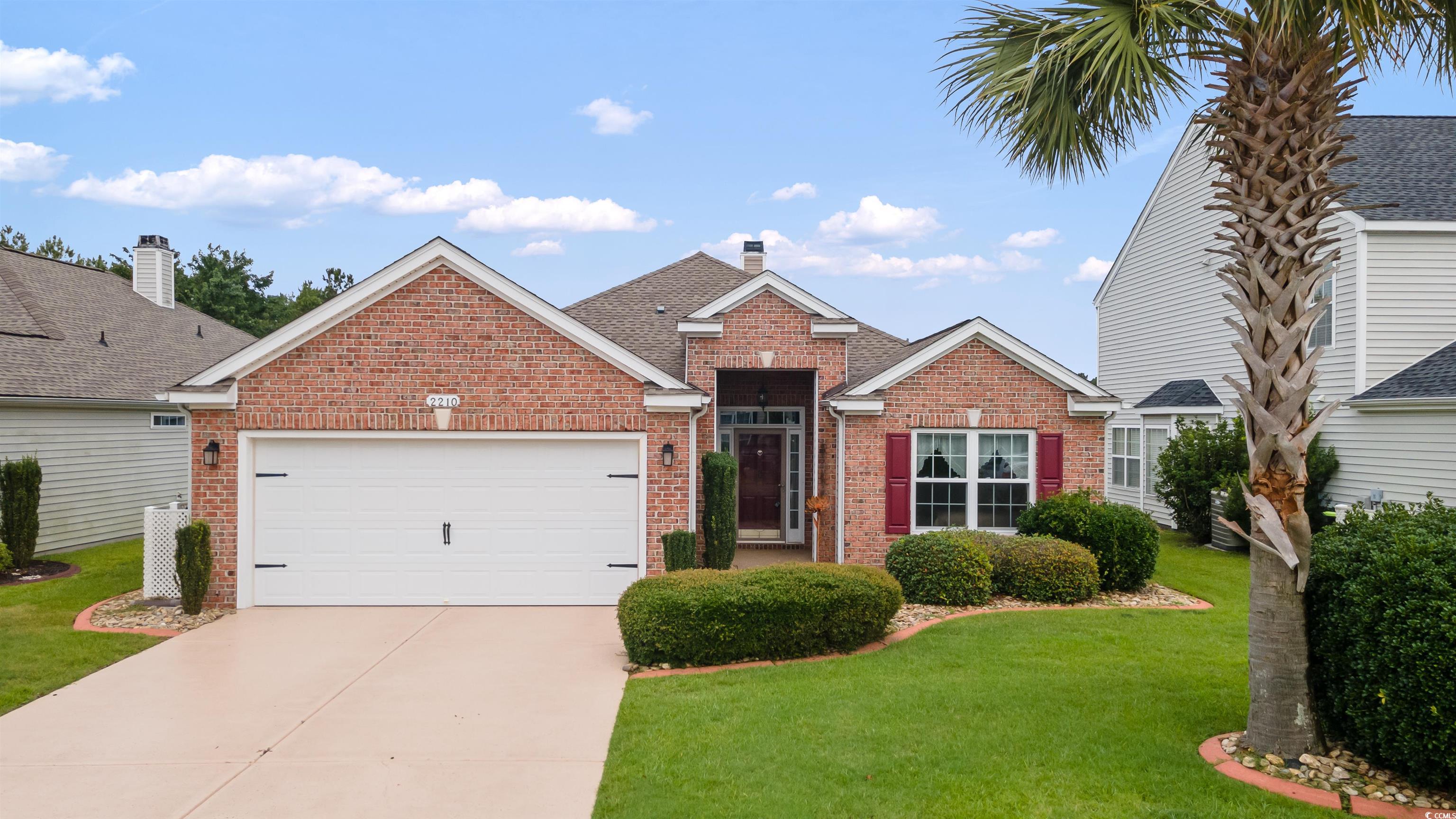 Traditional home with brick siding, concrete drive
