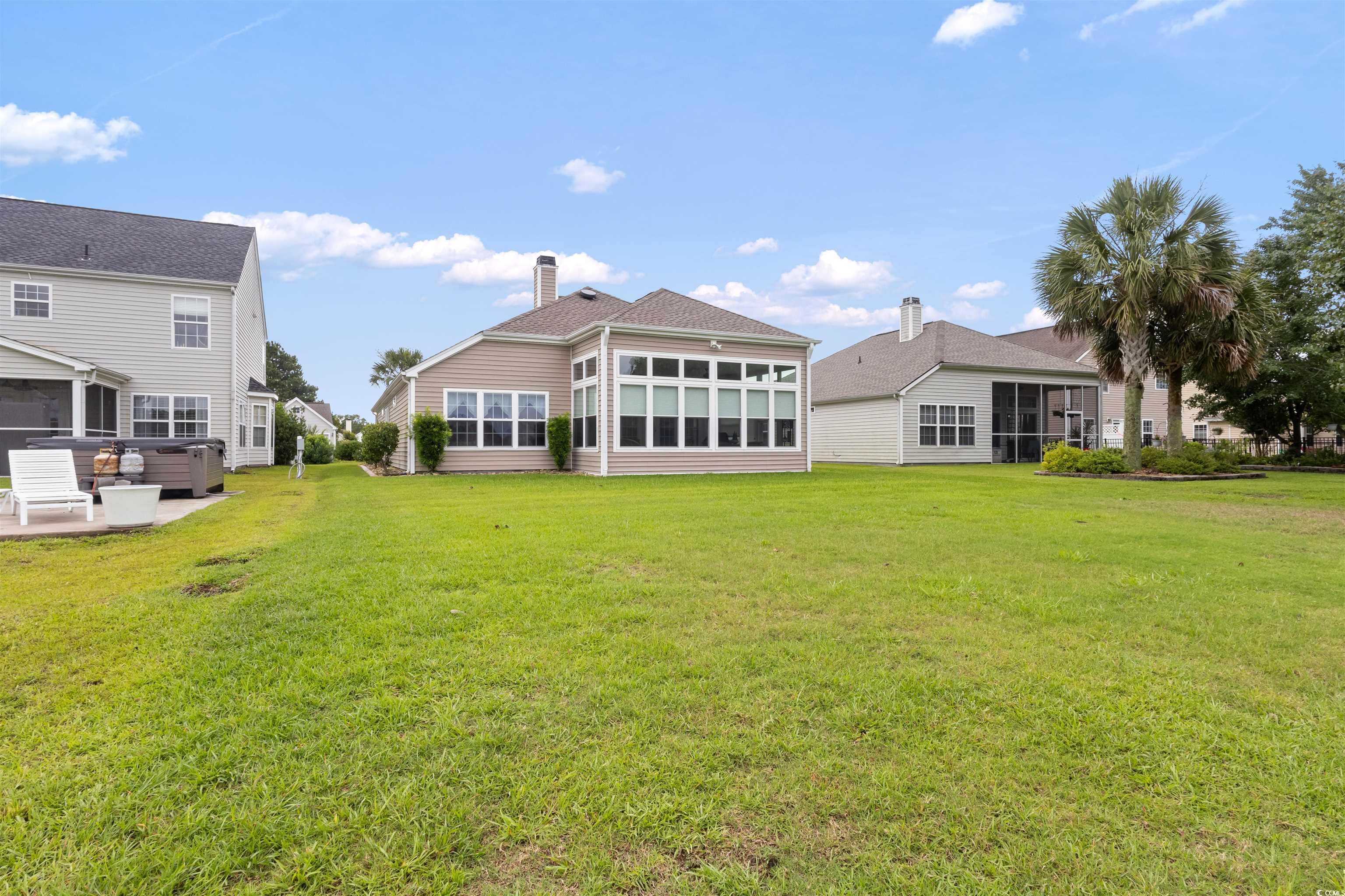 2210 Haystack Way Myrtle Beach, SC 29579 - Photo 28 of 33 Rear view of house featuring a sunroom, a yard, an