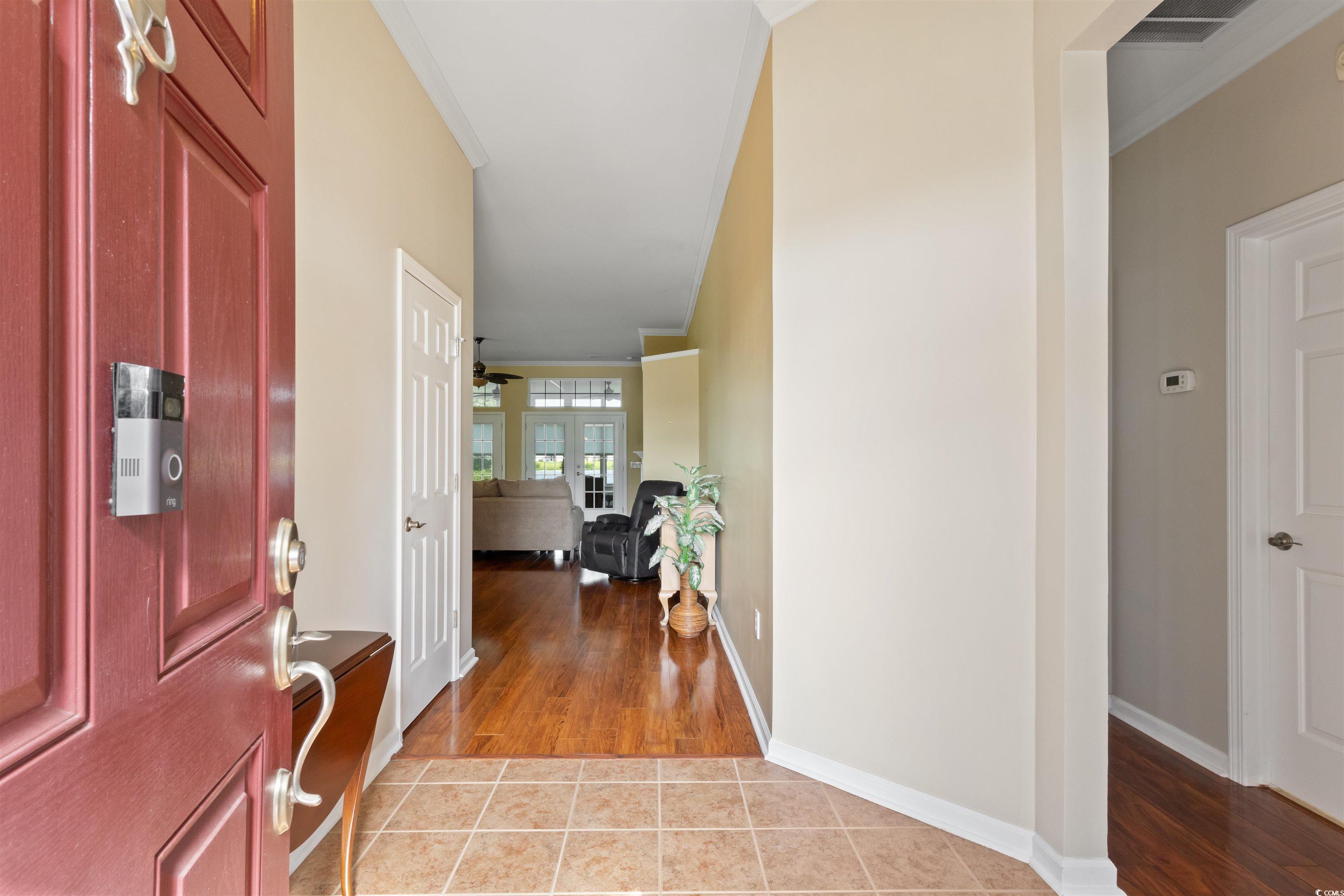 Entrance foyer with light wood-style flooring and