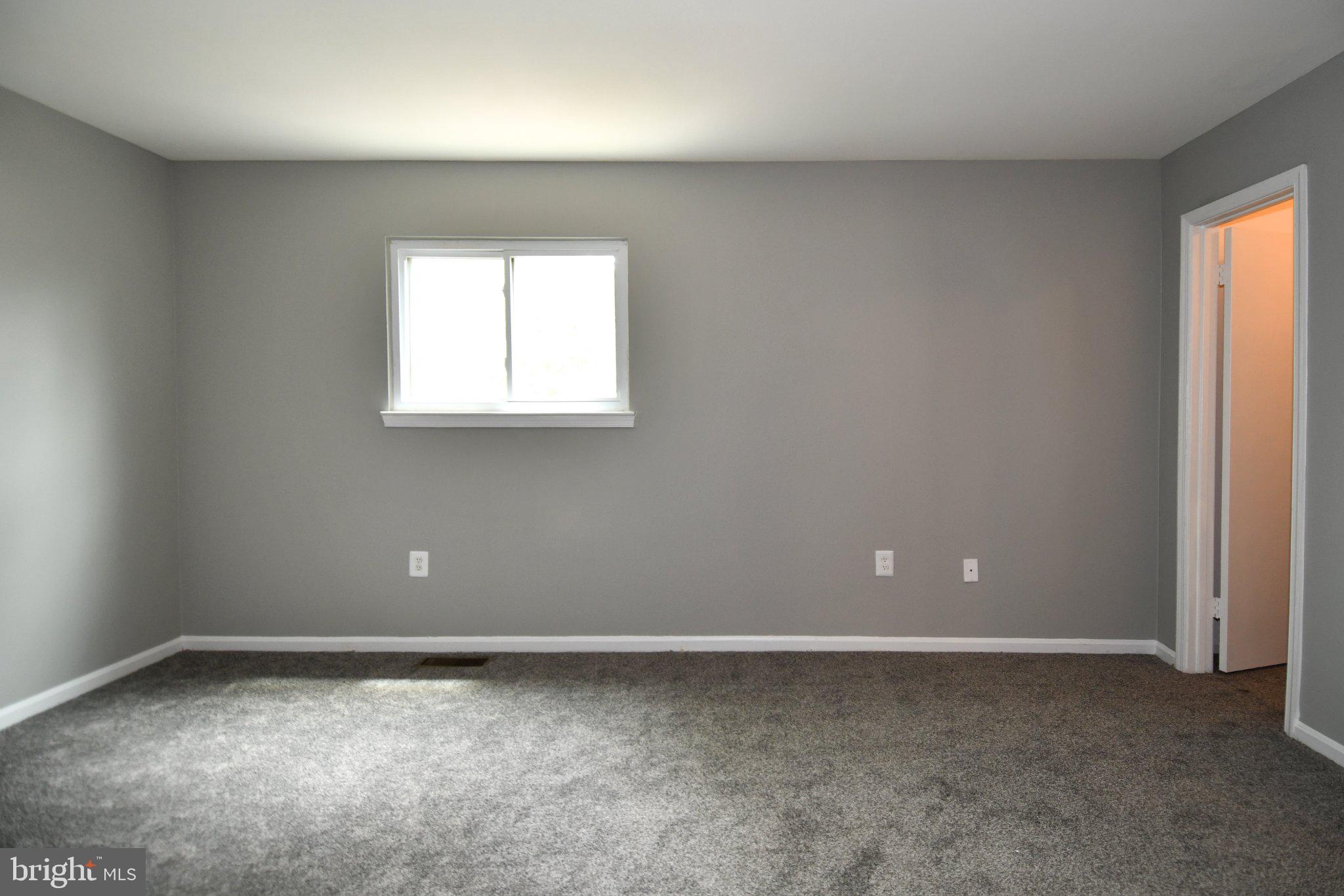 7737 Merrick Lane Landover, MD 20785 - Photo 17 of 34 Spacious room with soft gray tones.
