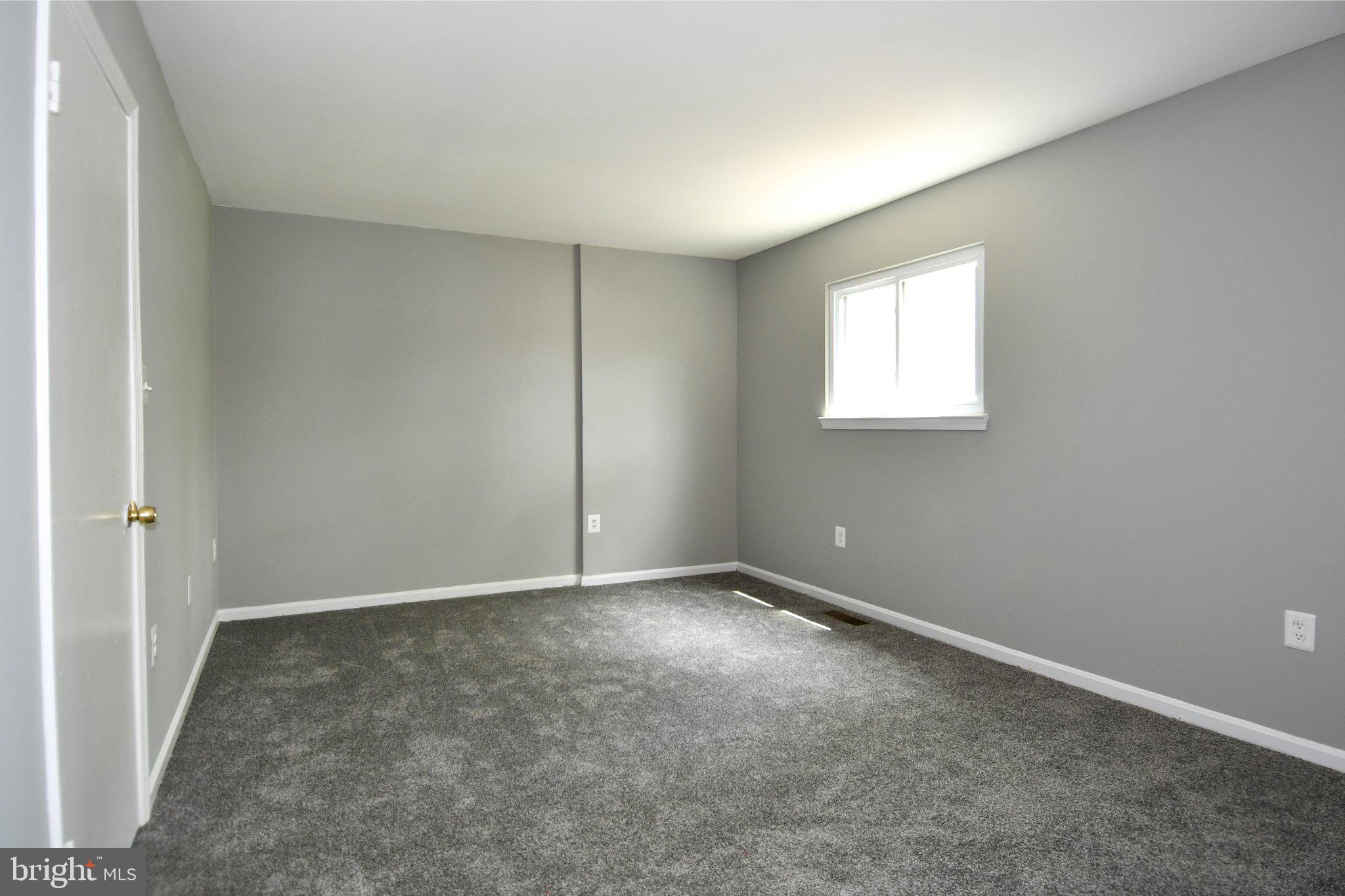 7737 Merrick Lane Landover, MD 20785 - Photo 18 of 34 Spacious room with soft gray tones.
