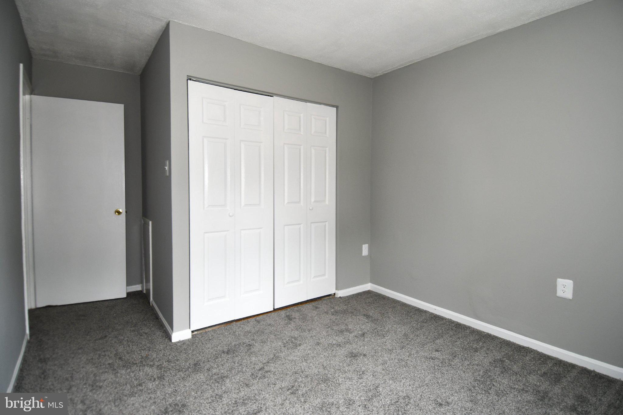 7737 Merrick Lane Landover, MD 20785 - Photo 26 of 34 Spacious room with modern gray tones.
