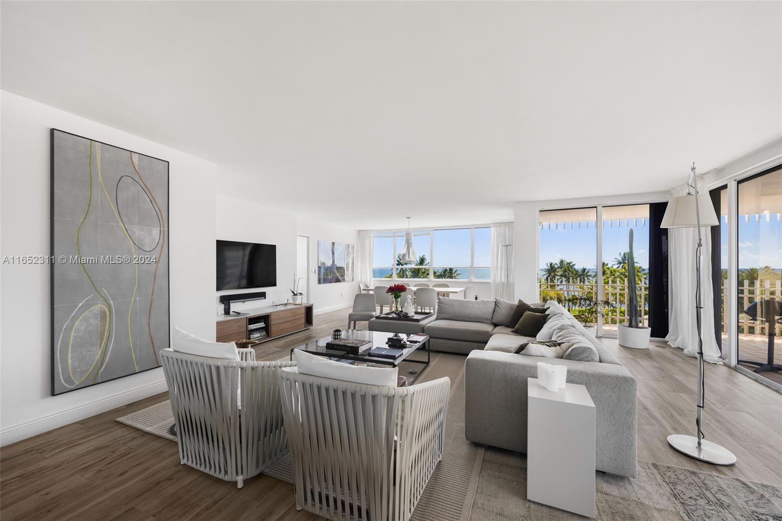 2 Grove Isle Drive, Unit B402 Miami, FL 33133 - Photo 1 of 35 a living room with furniture and a flat screen tv