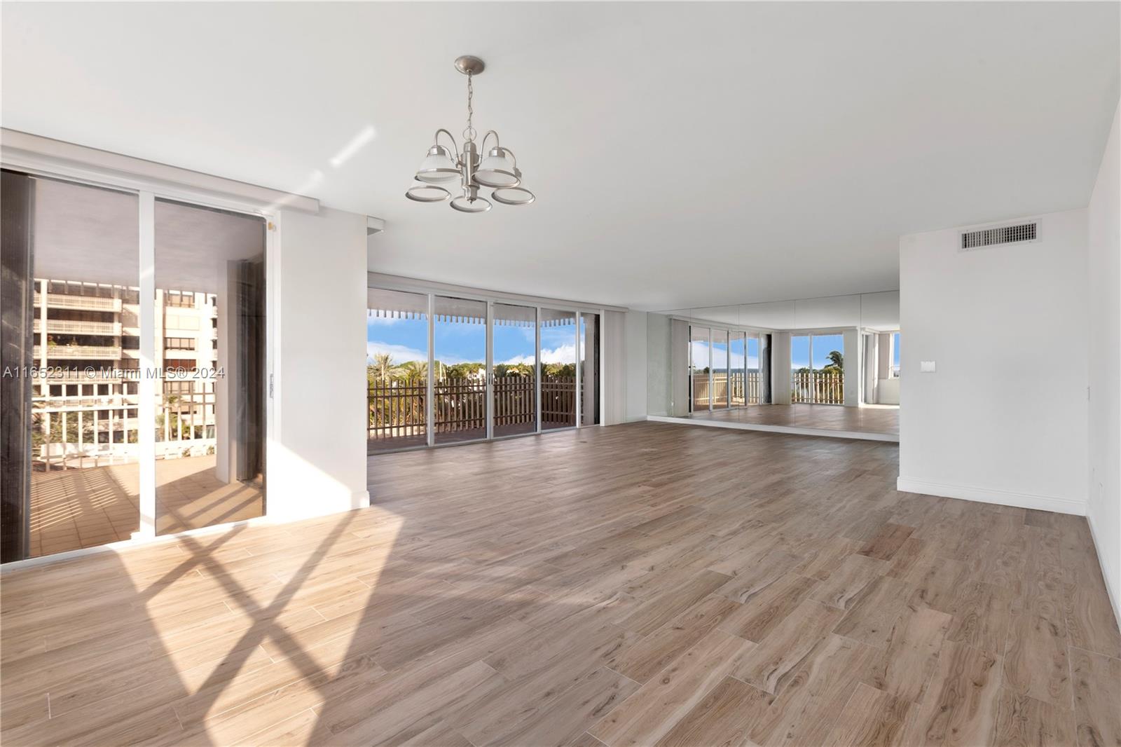 2 Grove Isle Drive, Unit B402 Miami, FL 33133 - Photo 12 of 35 a view of empty room with wooden floor and fan
