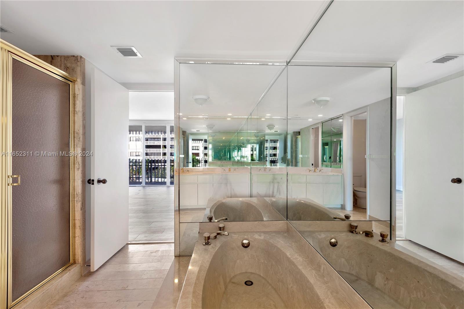 2 Grove Isle Drive, Unit B402 Miami, FL 33133 - Photo 15 of 35 a bathroom with a tub shower and sink