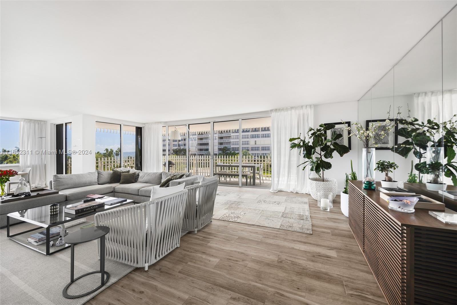 2 Grove Isle Drive, Unit B402 Miami, FL 33133 - Photo 2 of 35 a living room with furniture and a flat screen tv