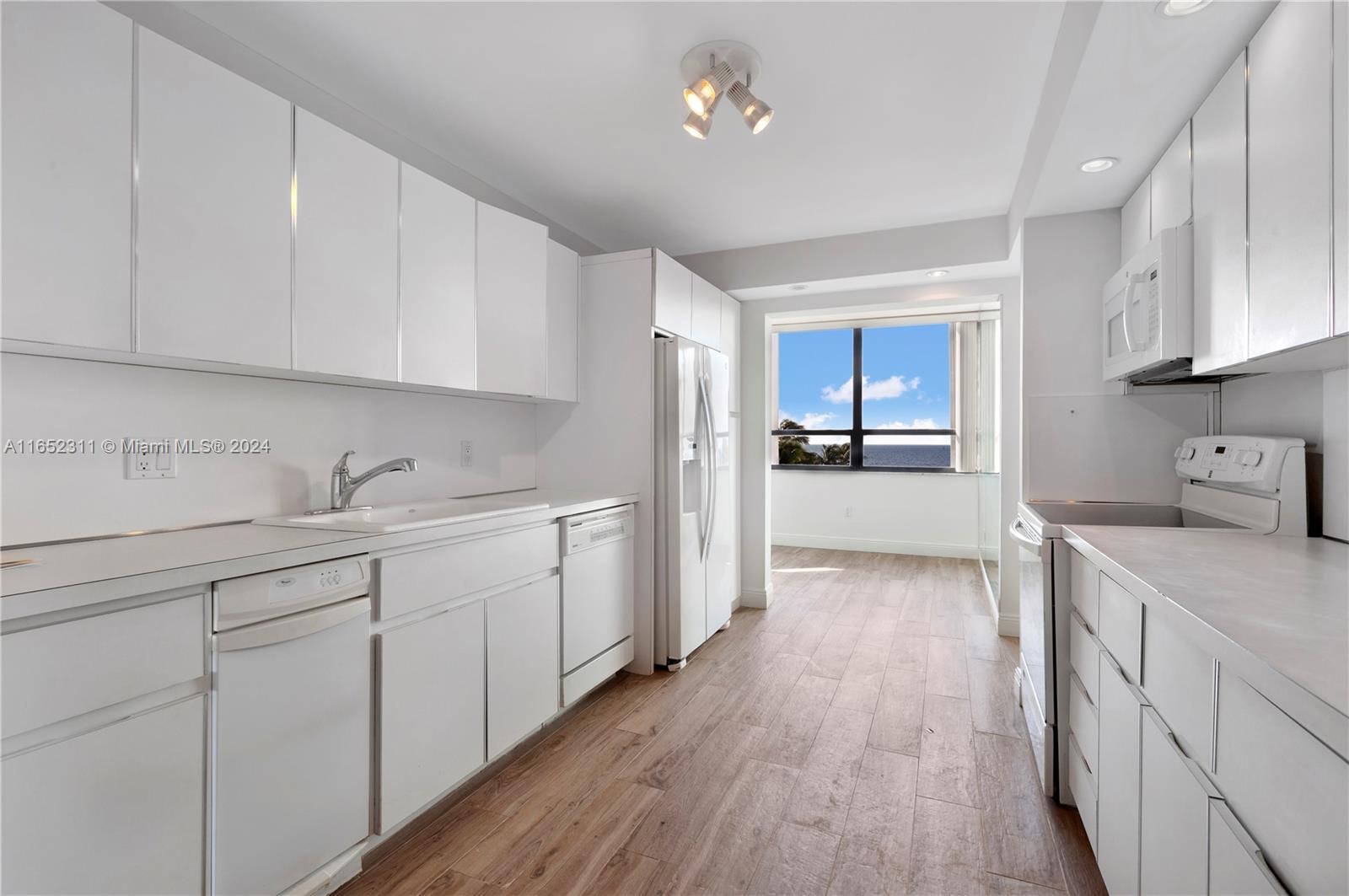 2 Grove Isle Drive, Unit B402 Miami, FL 33133 - Photo 21 of 35 a kitchen with cabinets and stainless steel appliances