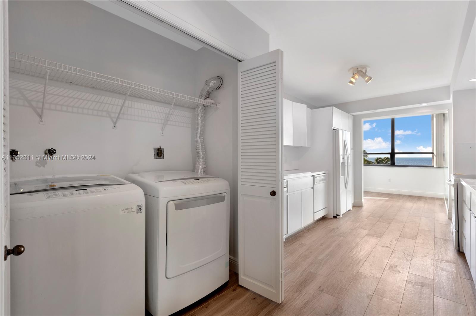 2 Grove Isle Drive, Unit B402 Miami, FL 33133 - Photo 24 of 35 a view of a storage & utility room with fridge and wooden floor