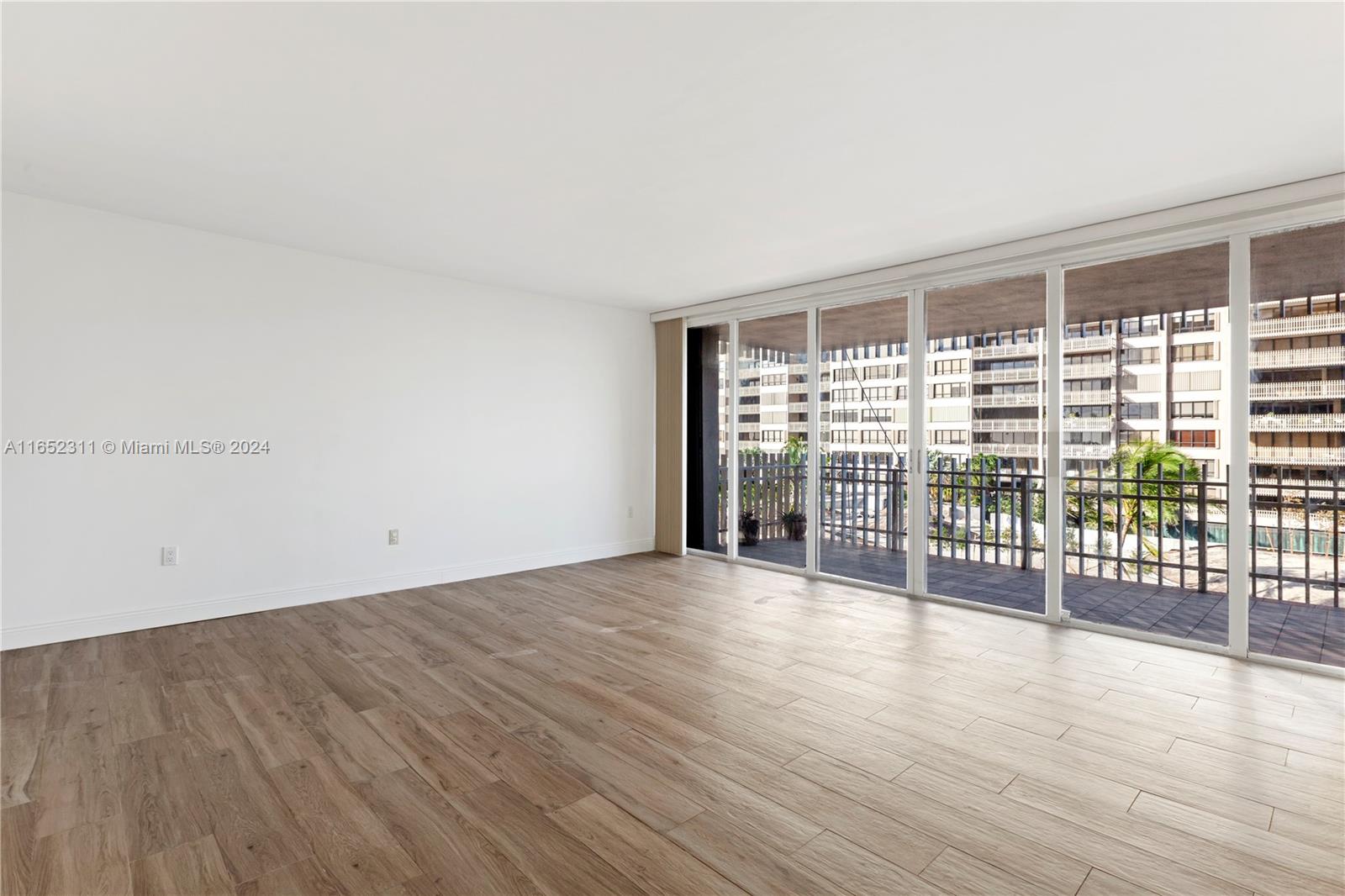 2 Grove Isle Drive, Unit B402 Miami, FL 33133 - Photo 25 of 35 wooden floor in an empty room with a window
